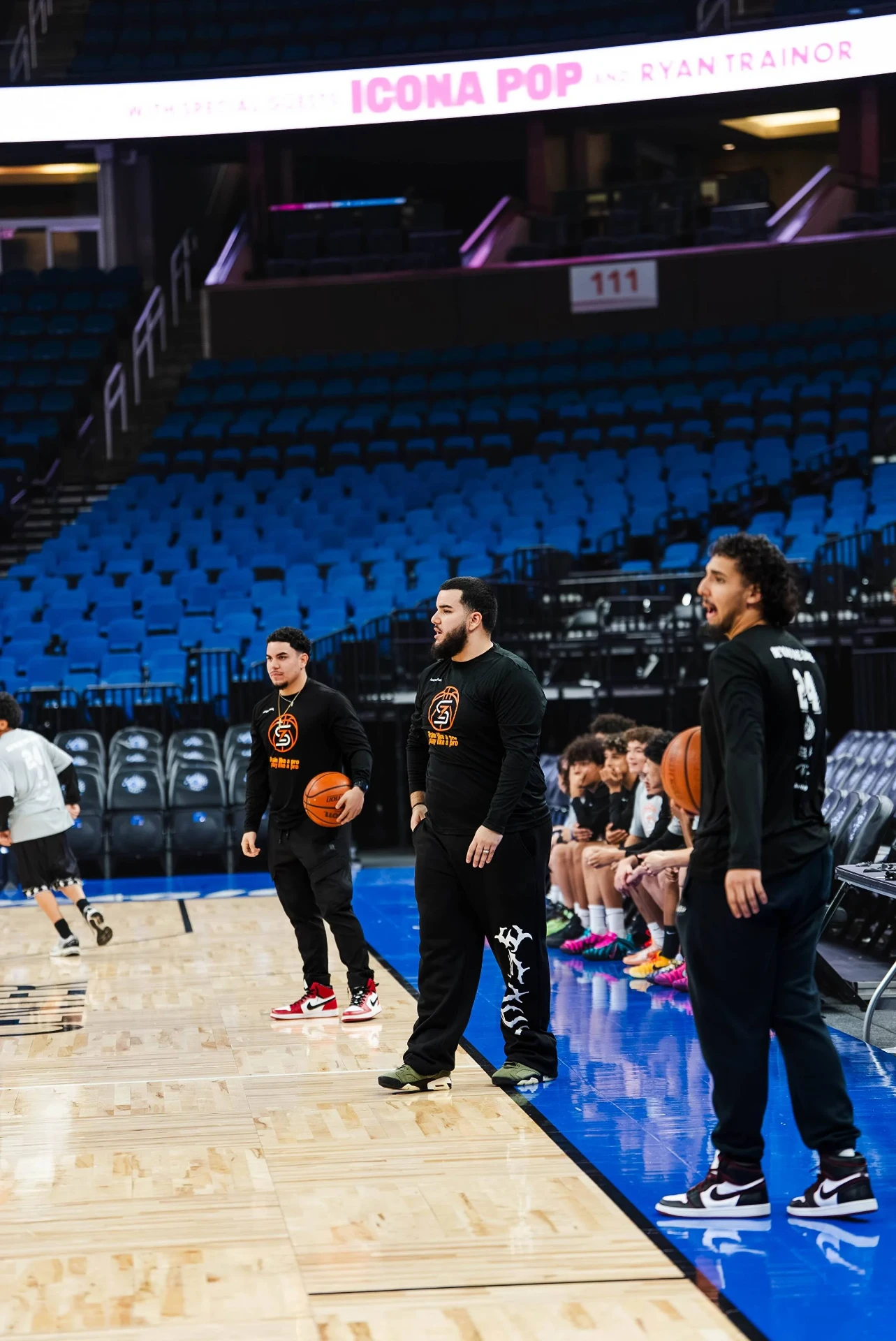 Young player rising for a jump shot in an NBA arena