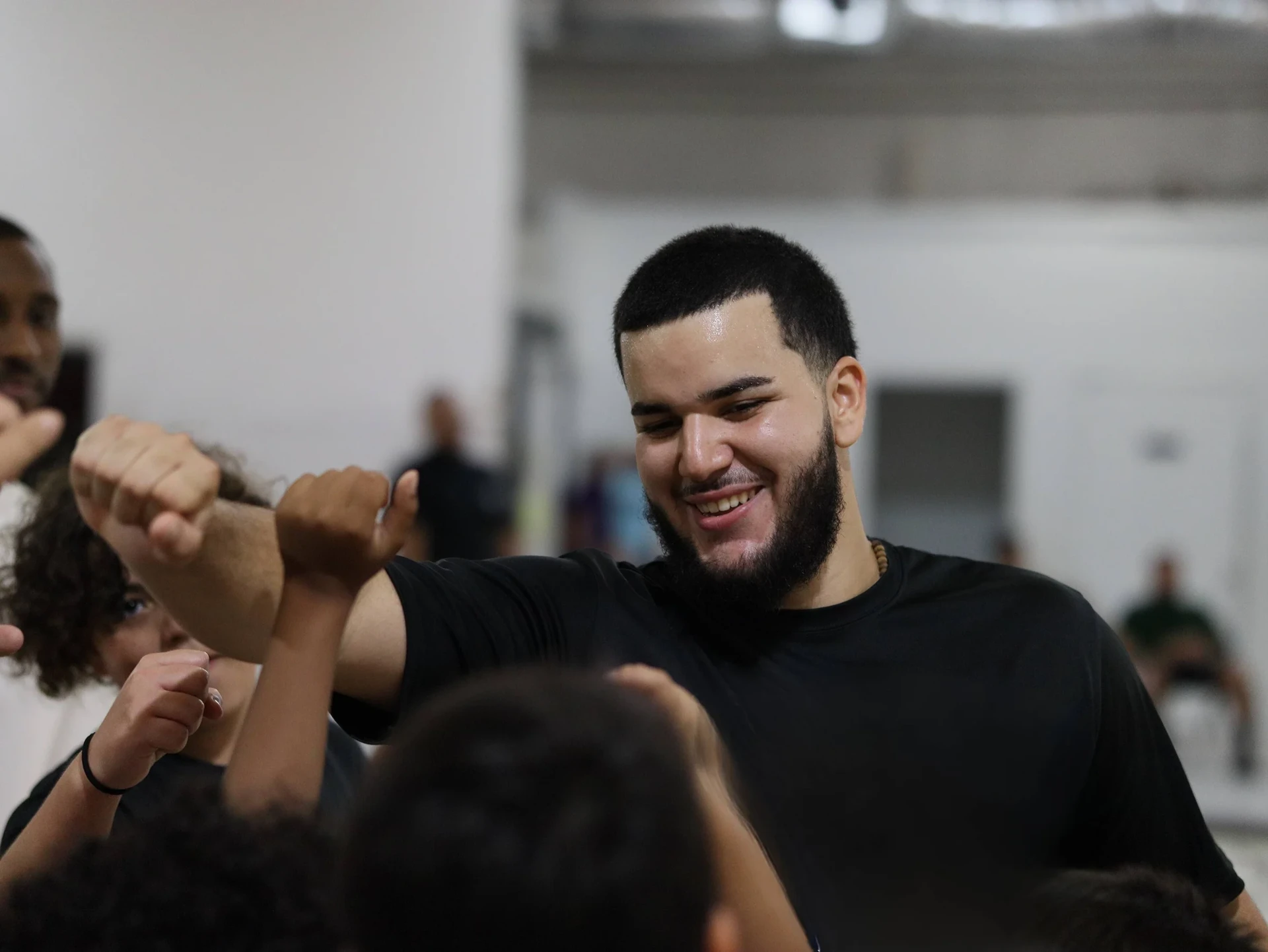 Coach celebrating with young players after a workout