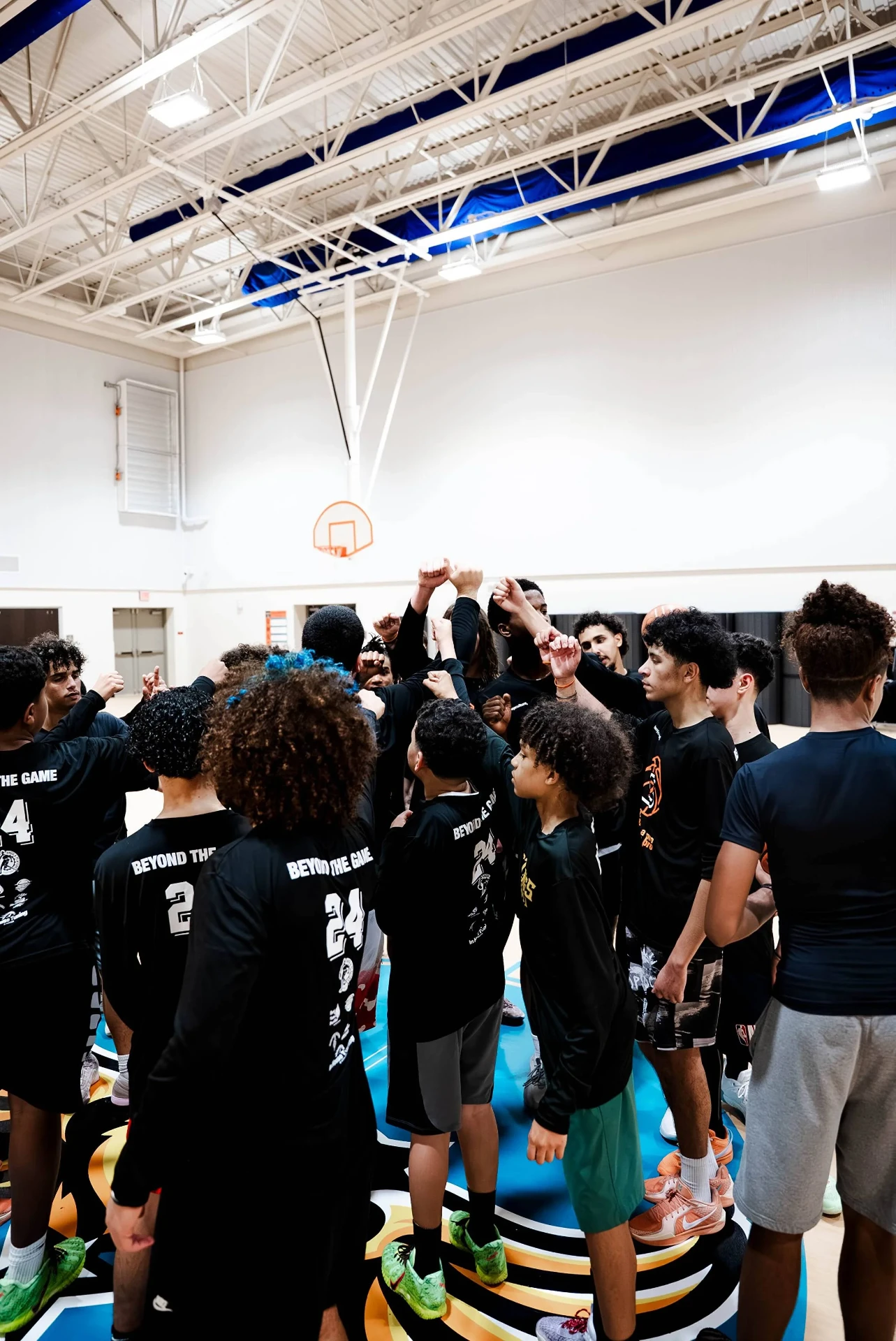 Team huddle with hands raised before a Zeus Skills session