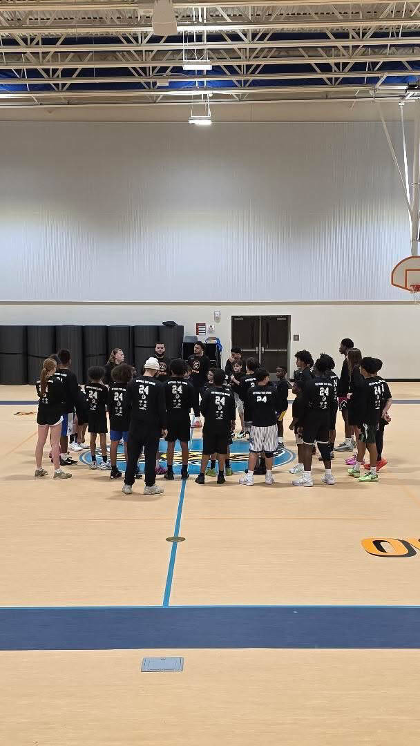 Team huddle at center court during a Zeus Skills camp